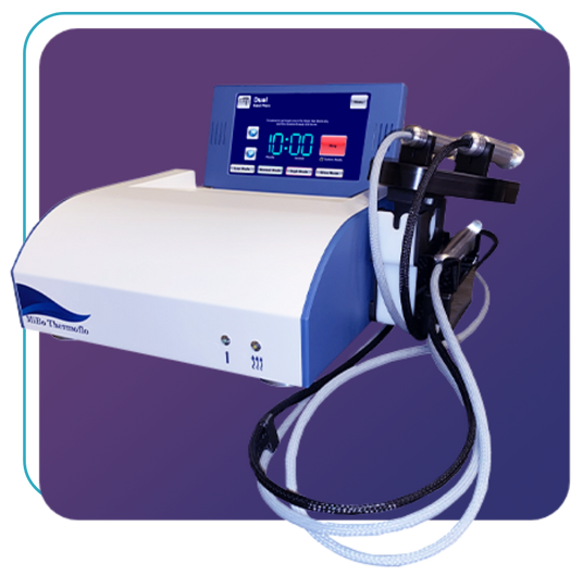 A medical device with a digital display showing 10:00 and buttons. Attached are two cords with handheld applicators. The main body is white and blue, set against a purple background.