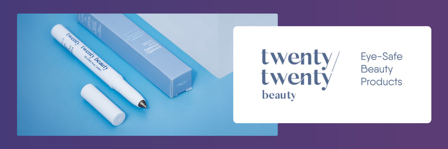 A Twenty/Twenty Beauty eye makeup pencil with its cap off lies next to its blue packaging box on a blue surface. The text twenty/twenty beauty and Eye-Safe Beauty Products is displayed on the right against a white background.