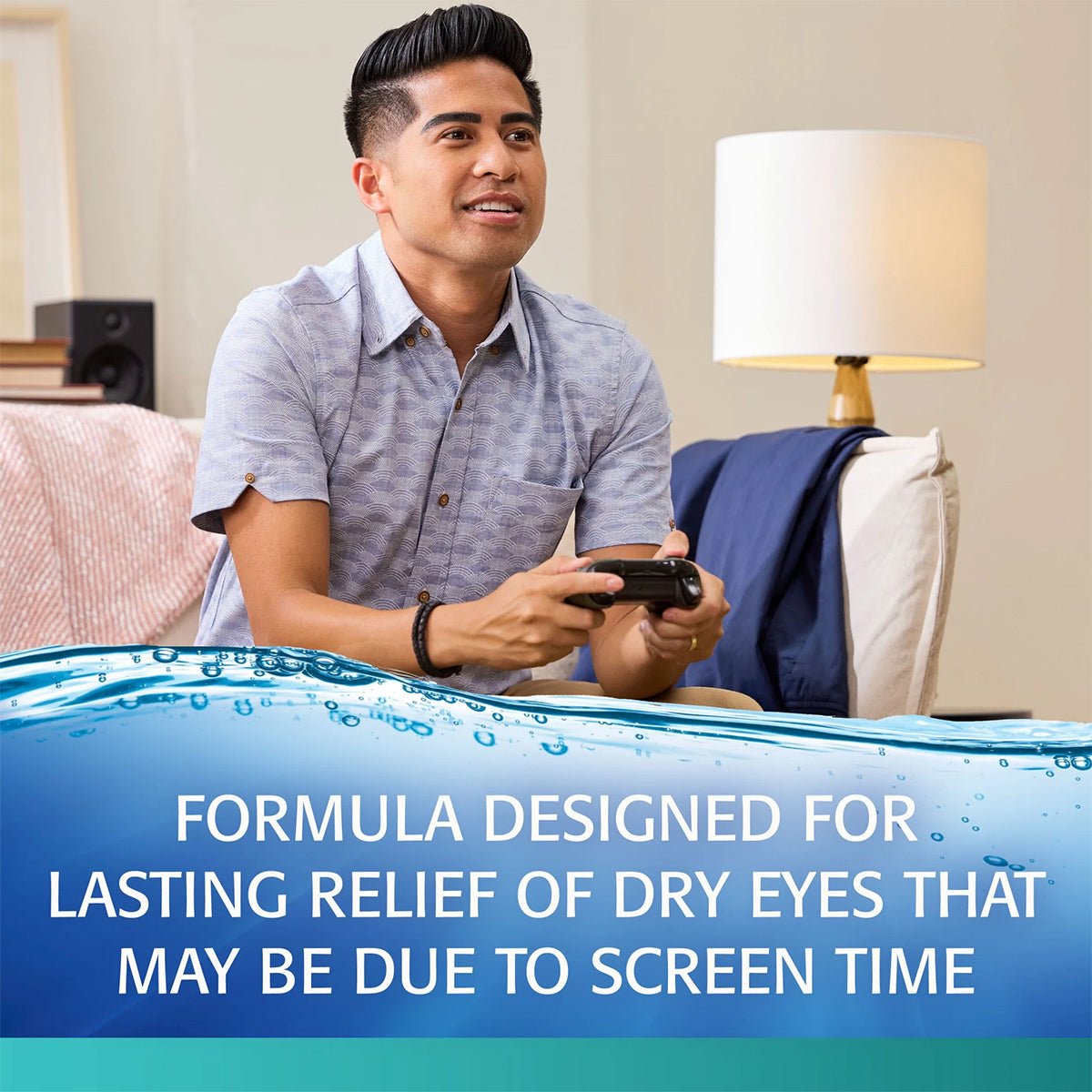 A focused gamer grips a controller on the couch, with REFRESH® DIGITAL Lubricant Eye Drops by Abbvie providing lasting relief for dry eyes caused by digital eye strain. A lamp and pillows accent the background.