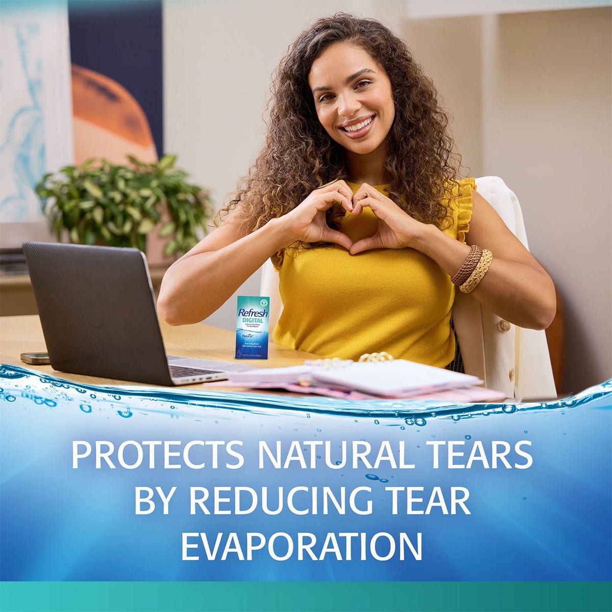 A person with long curly hair forms a heart shape with their hands at a desk. On the desk sit a laptop and a box labeled REFRESH® DIGITAL by Abbvie, featuring HydroCell Technology. The text reads, “Protects natural tears by reducing tear evaporation.”.