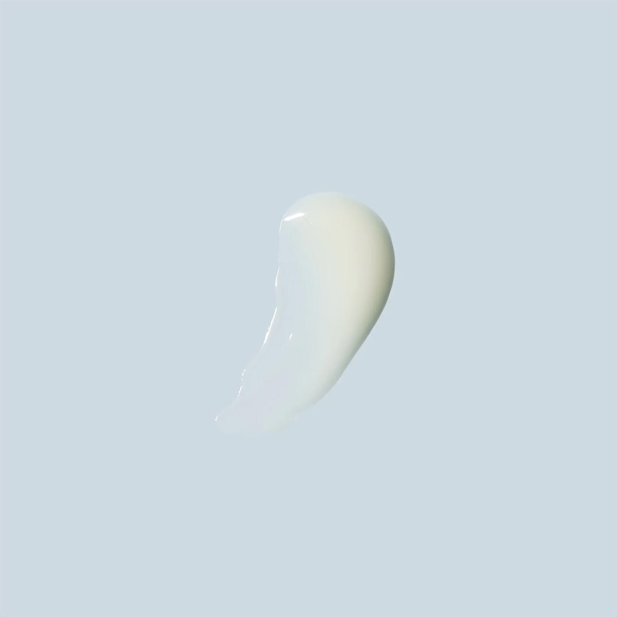 A white liquid smear on a light gray background evokes the power of Daily Practice Firm & Restore Eye Cream – Smooth, Hydrate & Lift (15mL) to reduce fine lines and enhance skin texture.