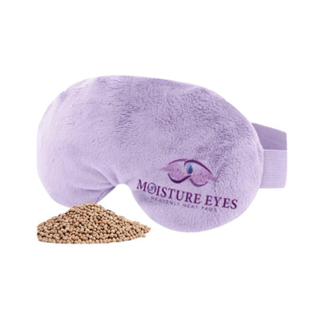 Lavender plush eye mask embroidered with Moisture Eyes and an eye logo, featuring clay bead technology from Dry Eye Guys. Shown with a mound of beige beads.