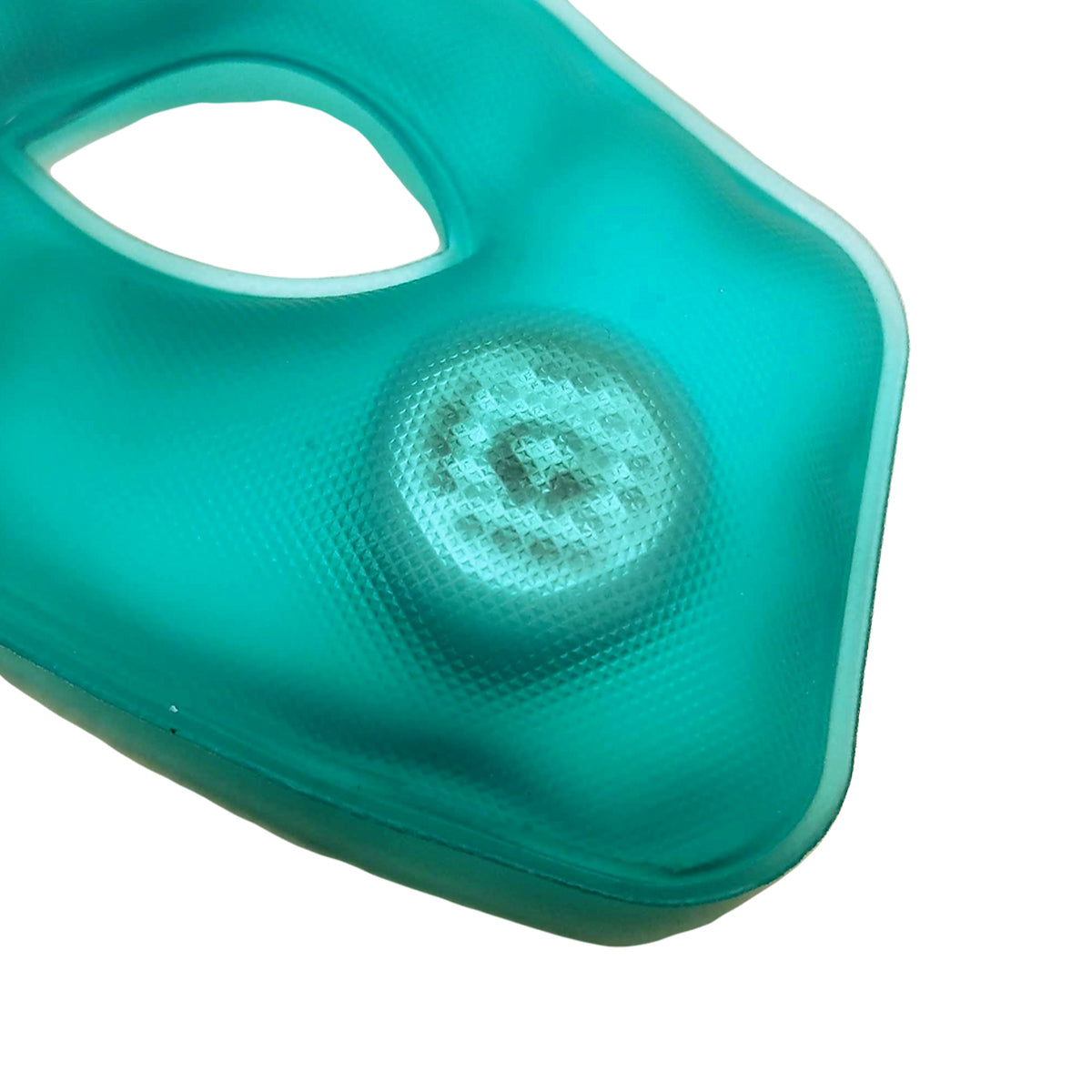 Close-up of a teal fabric mask with a raised circular mesh, ideal for thermal therapy. The soft mask by TearRestore features an oval cutout for comfort and focuses on texture and color, potentially offering dry eye relief when used with TearRestore Replacement Heat Packs (2 Pack) 6-month Supply.