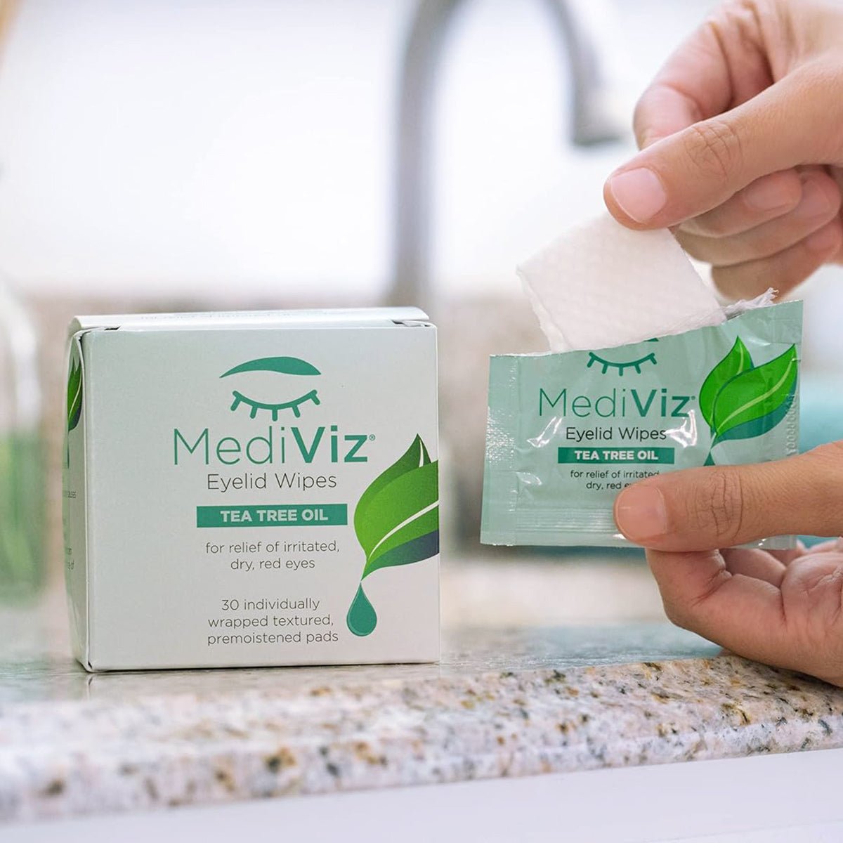 A hand opens a package of PRN - Physician Recommended Nutriceuticals MediViz Tea Tree Eyelid Wipes 3-Pack on a countertop, with packaging featuring a leaf and eyelash logo, offering relief for irritated, dry eyes and combating Demodex Eyelash Mites and clogged meibomian glands.