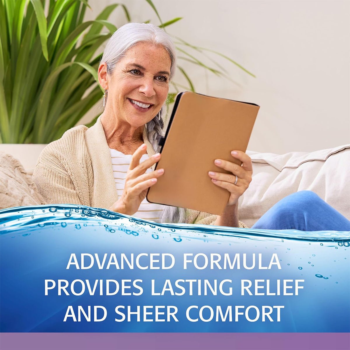 A smiling older woman with gray hair sits on a couch using a tablet, wearing a beige cardigan over a striped shirt. Text reads: Refresh Optive® Gel Drops – Lubricant Eye Gel by Abbvie offers lasting relief and sheer comfort for dry eye symptoms.