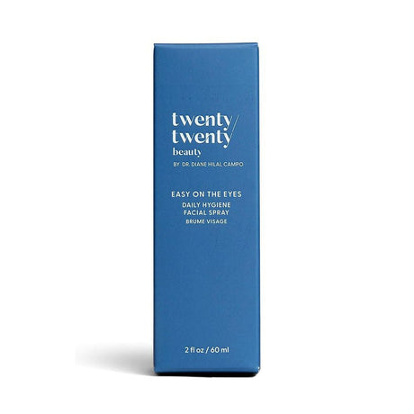 A blue rectangular box stands upright, labeled with twenty twenty and Easy on the Eyes Daily Hygiene Facial Spray in white. This 60ml ophthalmologist-developed face mist uses hypochlorous acid for a calming effect. Brand: Twenty Twenty by Dr. Diane Hilal-Campo.