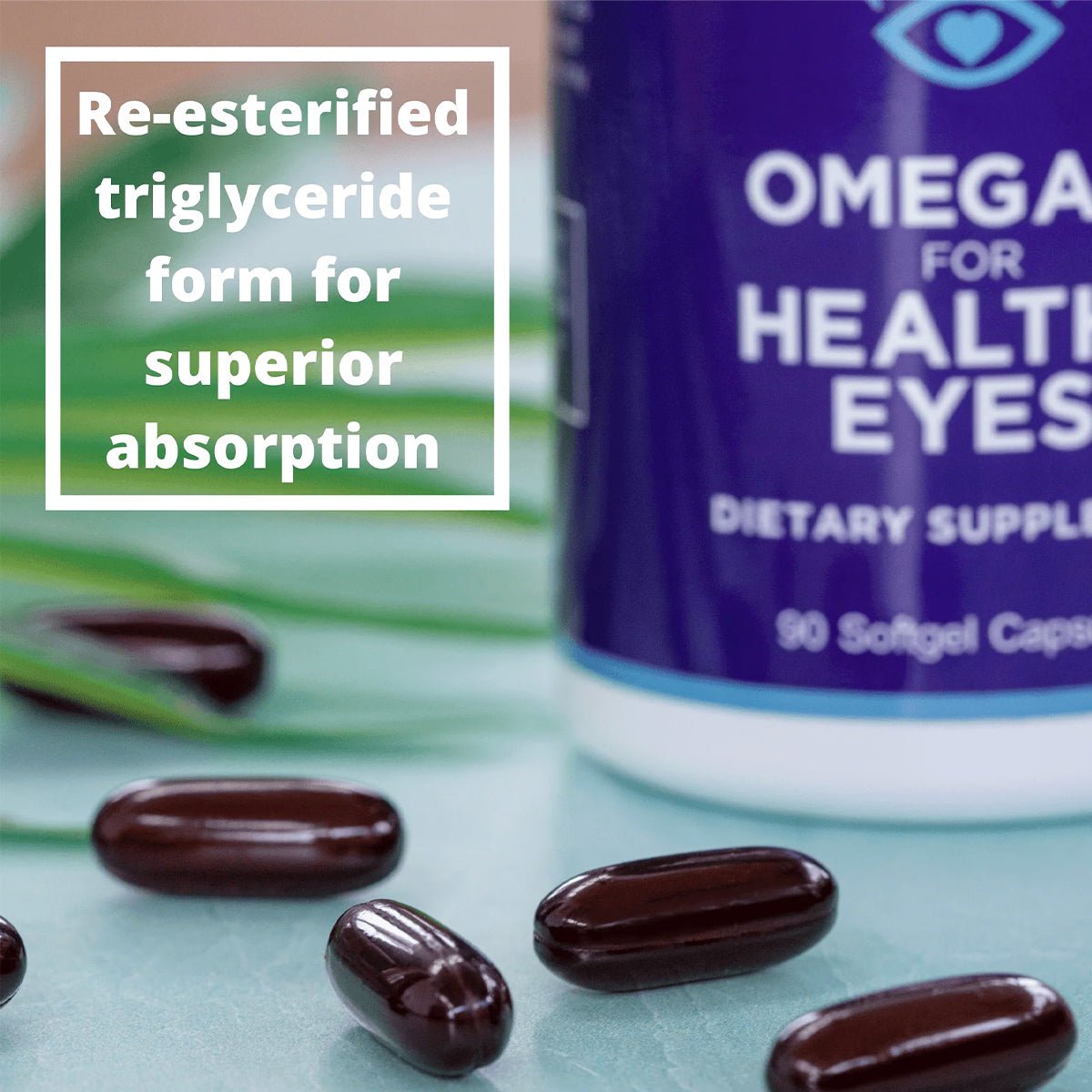 Close-up of dark capsules near a purple and white bottle labeled Heyedrate Omega 3 For Eye Health (1 Month Supply), ideal for eye health. A text box states: Re-esterified triglyceride form for superior absorption by PRN - Physician Recommended Nutriceuticals. Green leaves are visible.