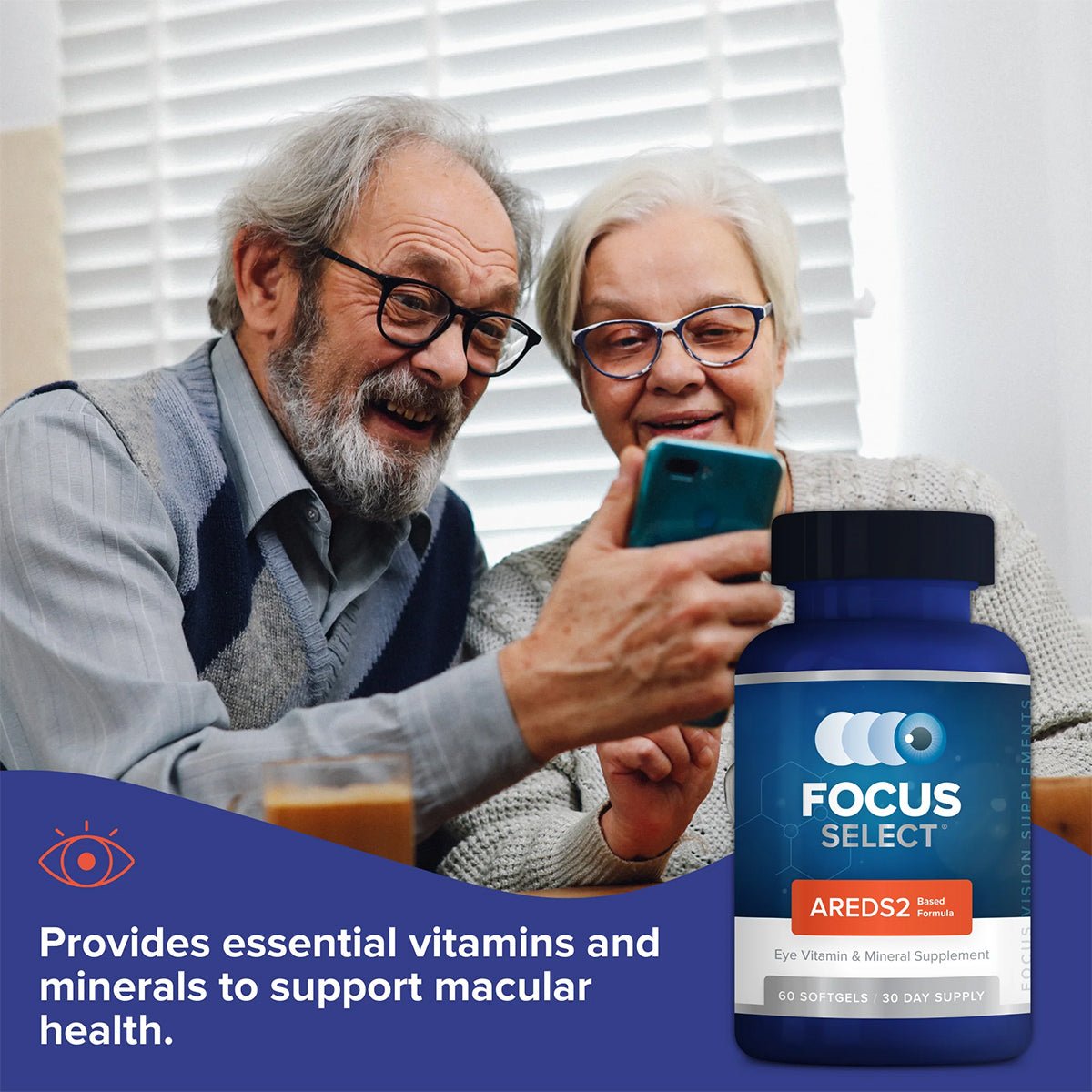 An elderly couple sits at a table, closely examining a phone. In the foreground, a bottle of Focus Select Supplement by Focus Vitamins, featuring an AREDS2 formula for supporting macular degeneration (180ct. 90 Day Supply), is prominently displayed.