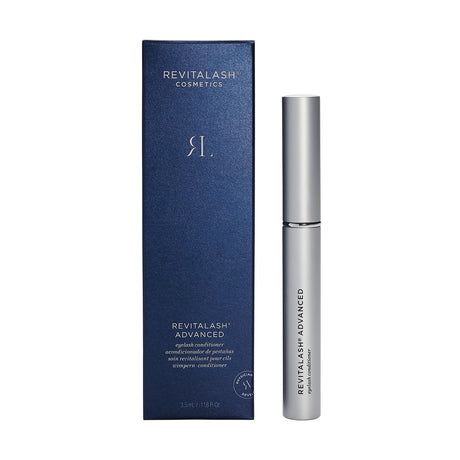 A sleek silver tube of RevitaLash Advanced Eyelash Conditioner and Enhancing Serum (3 Sizes) sits beside its blue packaging, featuring RevitaLash branding and white text detailing the iconic product.