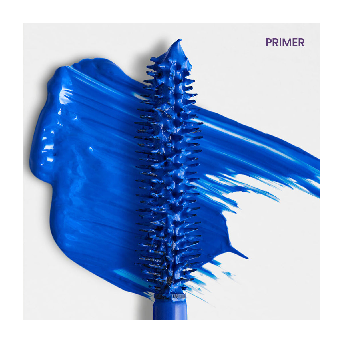 A RevitaLash Double-Ended 2-in-1 Lash Primer & Mascara Volume Set wand lies diagonally on a white background with a thick, vivid blue brushstroke and PRIMER elegantly placed in the upper right corner.