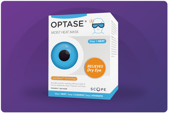 Box of OPTASE Moist Heat Mask on a purple background. Features a graphic of a large blue eye and text highlighting RELIEVES Dry Eye. The packaging emphasizes three steps: HEAT, CLEANSE, and HYDRATE.