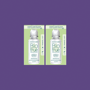 Two BioTrue Multipurpose Contact Lens Solution Travel Kits (2x 2oz/60mL) from Bausch + Lomb rest on a purple background, each featuring a BioTrue bottle that highlights the solutions hydration and clarity benefits for lenses.