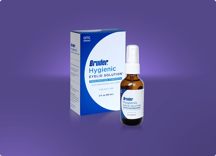 A brown spray bottle labeled Bruder Hygienic Eyelid Solution is placed in front of its blue and white box. The wording on the box indicates its an OTC hygienic eyelid spray for daily use. The bottle and box are set against a purple gradient background.
