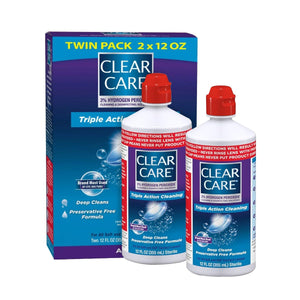 Two bottles of Alcon Clear Care Triple Action Cleaning Solution with Case (Twin Pack, 2 x 12 oz) are shown in front of a blue and purple box. This preservative-free formula uses a 3% hydrogen peroxide solution specifically for deep cleaning contact lenses.
