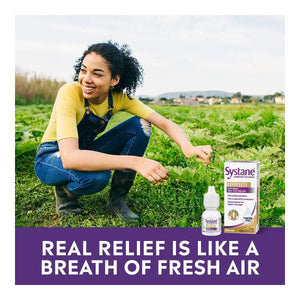 In a green field, a smiling woman with curly hair and a yellow shirt crouches beside Alcons Systane Complete Lubricant Eye Drops. Text reads, Real relief, featuring Nano-Droplet Technology, is like a breath of fresh air.