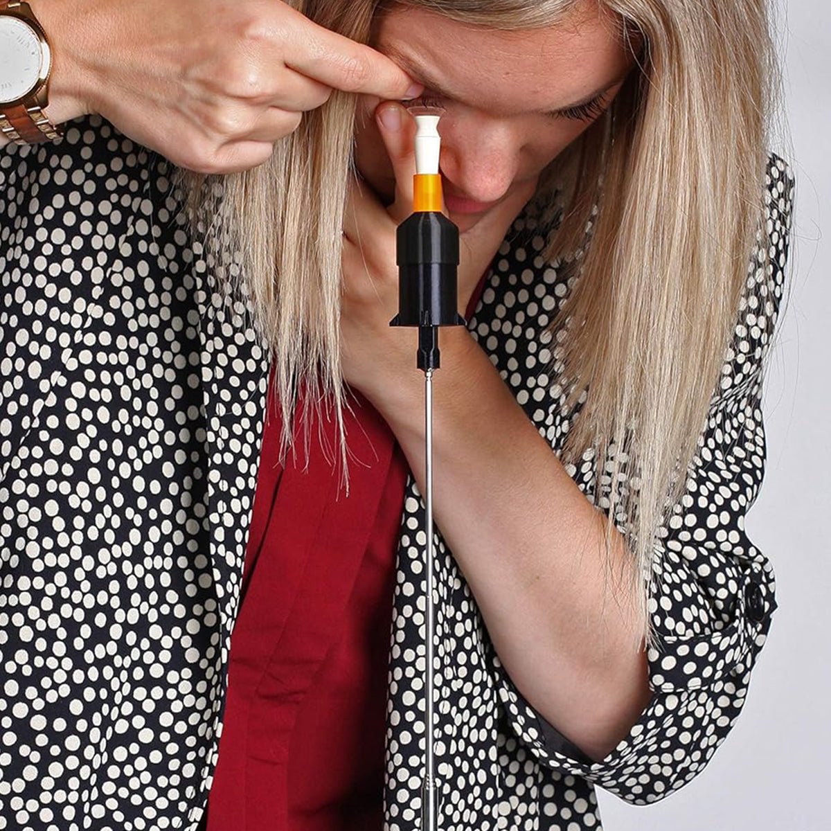 A blonde-haired person demonstrates lens insertion using the Augmented Vision Labs S5 Inserter—a black and white tool with adjustable height—while wearing a polka dot jacket over a red top. The demo includes free video training for scleral and hybrid lens insertion techniques.