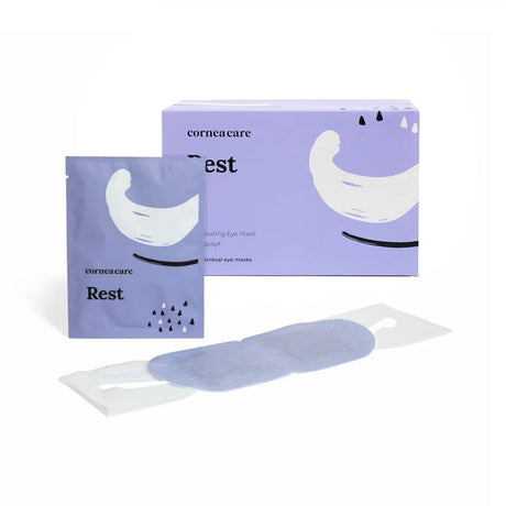 A single packet of CorneaCare Self Heating Warm Compresses is shown with its box. The light purple packaging features crescent graphics, highlighting Eye Hydration. One compress is partially visible, ready to provide soothing Dry Eyes Relief.