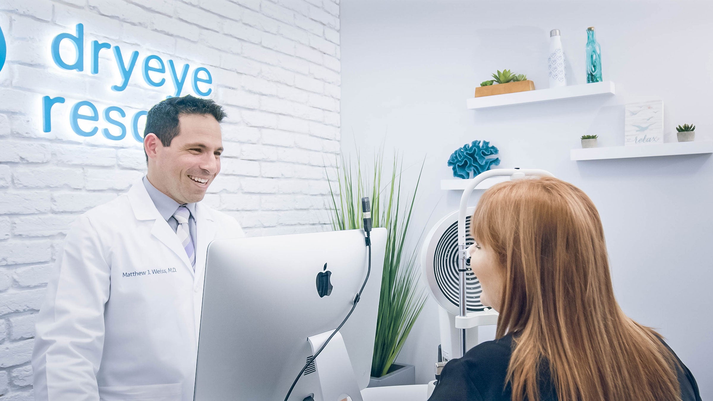Dry eye doctor speaking to patient