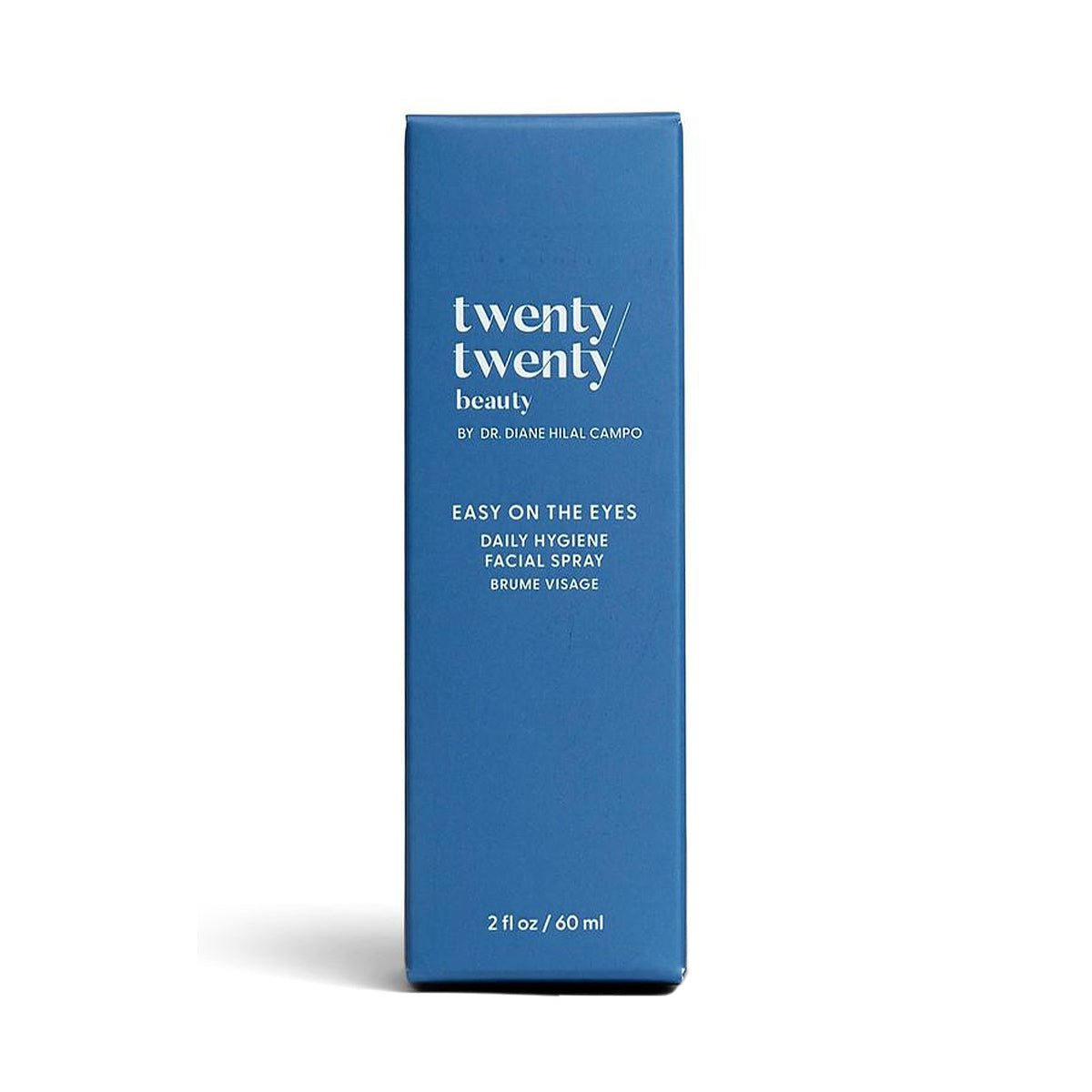 A blue rectangular box stands upright, labeled with twenty twenty and Easy on the Eyes Daily Hygiene Facial Spray in white. This 60ml ophthalmologist-developed face mist uses hypochlorous acid for a calming effect. Brand: Twenty Twenty by Dr. Diane Hilal-Campo.