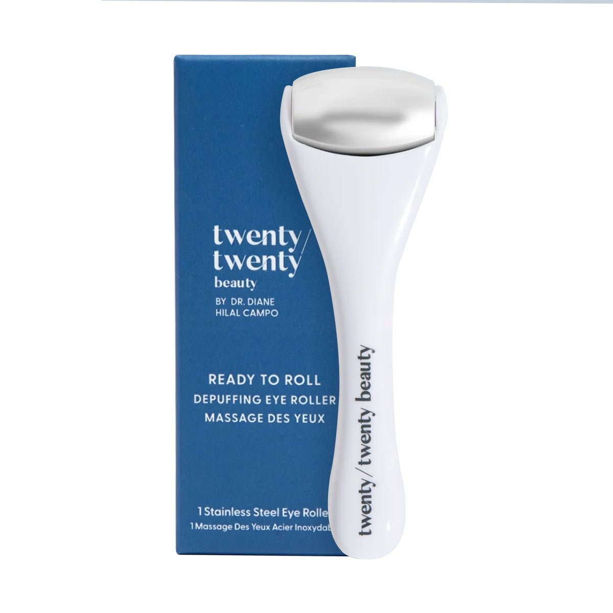 The Twenty Twenty Ready To Roll Depuffing Eye Roller, with a metal head, is beside its blue box labeled 1 Stainless Steel Eye Roller. This white roller is expertly crafted by Twenty Twenty to reduce puffiness and is ophthalmologist tested.