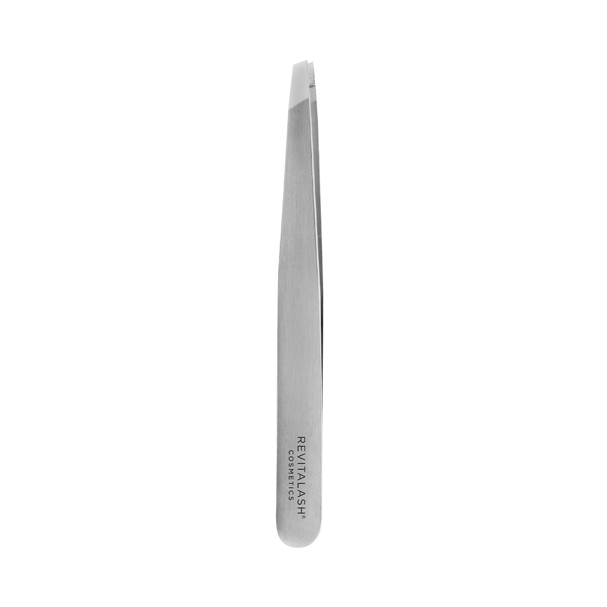 The close-up showcases the RevitaLash Precision Tweezer with a silver metallic finish and slanted tip, ideal for sculpting arched brows. RevitaLash is engraved on its stainless steel handle, set against a plain white background.