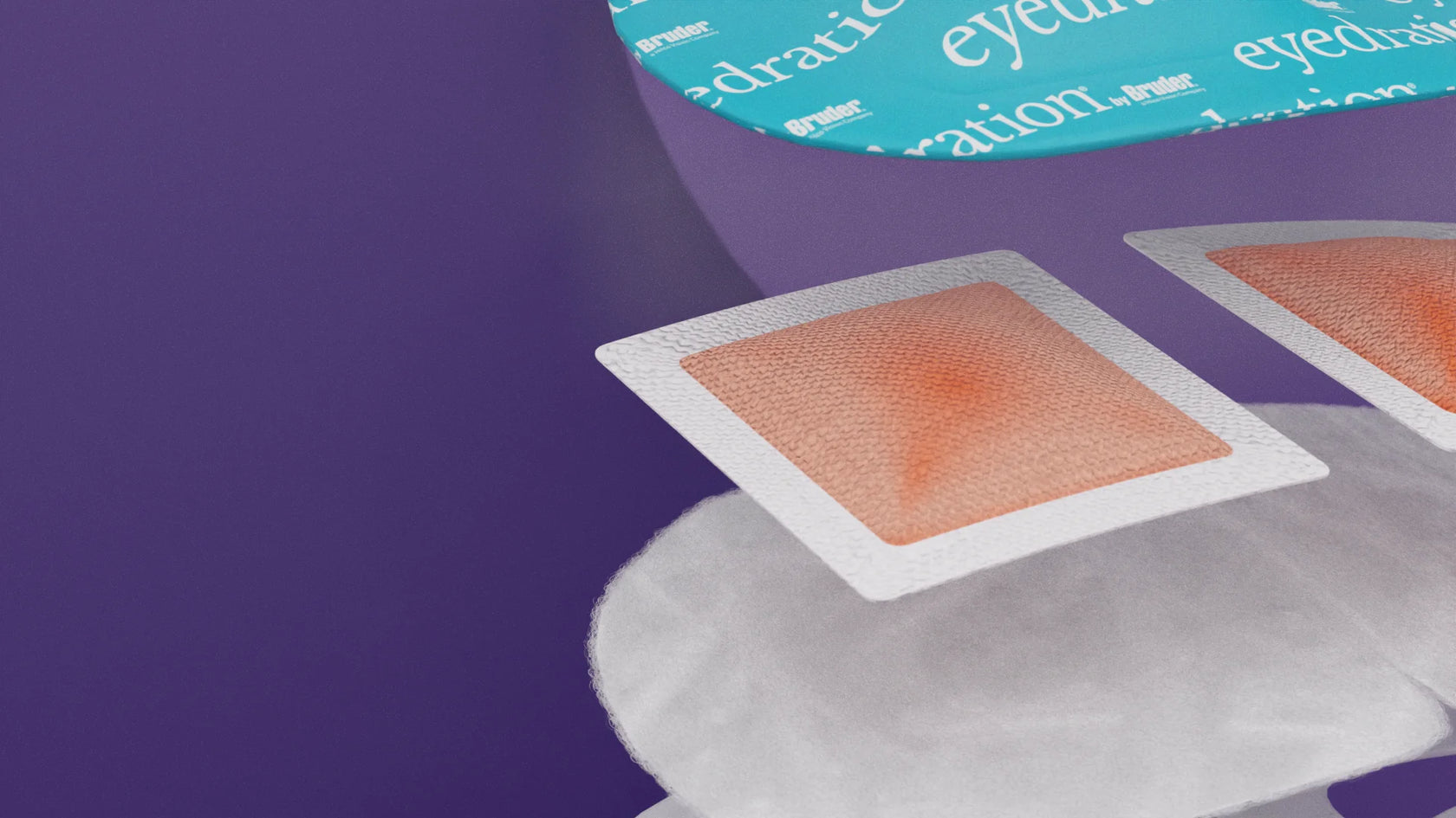 Close-up of eyepatch packaging with text eyedration by Bruder against a purple background. Visible are two patch-like items with a rectangular shape and a soft orange center.