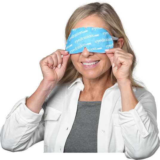 A smiling woman with light hair holds a blue eyepatch labeled eyedration over her eyes. She is wearing a white shirt over a gray top.